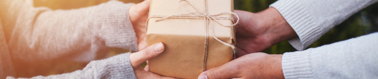 one person handing a gift to another